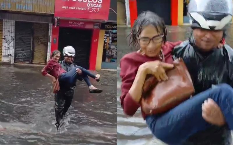 Mulher é levada nos braços para atravessar rua alagada no Centro de Fortaleza